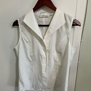 Crisp white sleeveless Calvin Klein button down shirt. Size 10. All cotton.